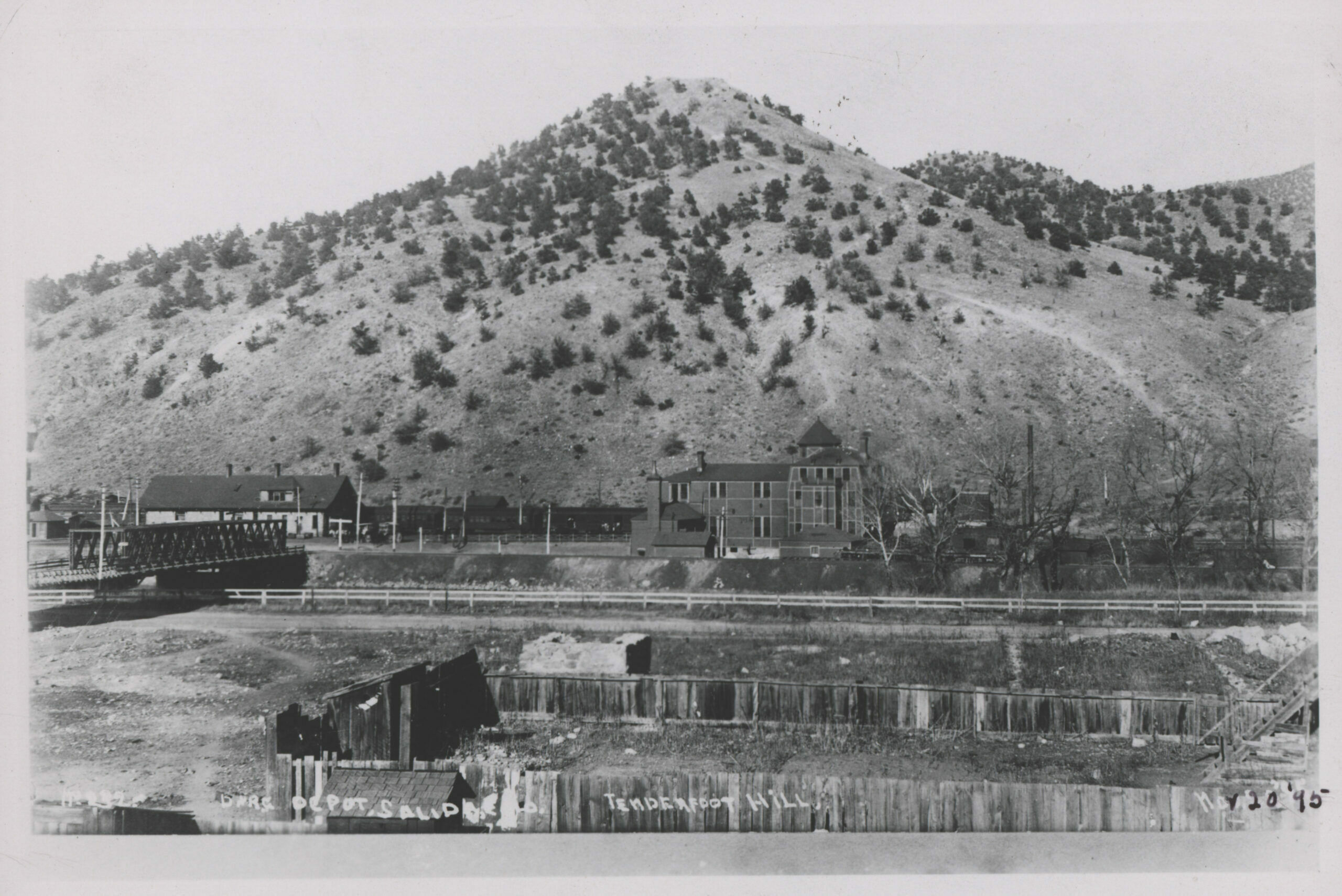 Trees on Tenderfoot Mountain are alive and well when this photograph was taken March 20, 1895. They began dying shortly after the smelter opened – upwind – in 1902, and by 1917 there were almost none left. Two foot paths up the mountain were used by hundreds of visitors who wanted to get a view of the city while they waited to change trains. The mountain was a favorite picnic spot for locals as well.  (1)