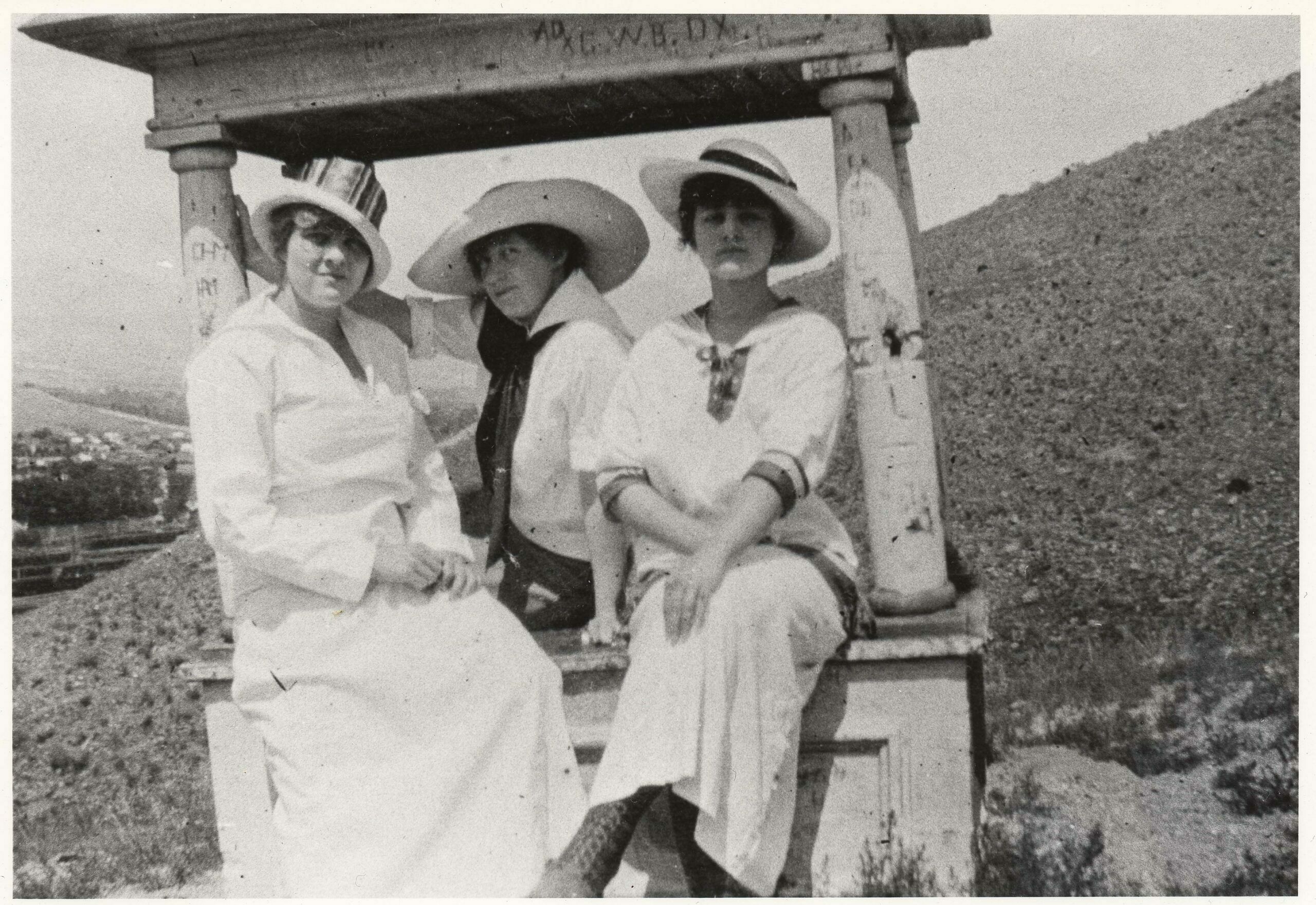 Although damaged and vandalized, pillars supporting the roof over the grave of Duke remained in place in the early 1920s when this trio of young Salida women (Nina Churcher (Thomson) on right) visited the monument on their way to a picnic at the Crater, a popular Sunday hiking destination.  (3)