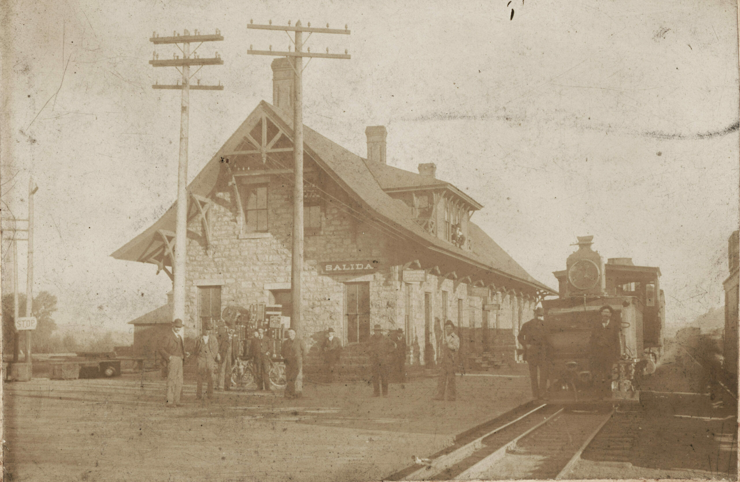 Although preparations began a year earlier, the third rail was laid through Salida during 1890. Addition of the outside rail allowed standard gauge as well as narrow gauge trains to operate over the entire Rio Grande system. Switches, frogs and rerailers – especially in the crowded Salida yards – were an engineering marvel. As late as 1890, the tender of this switcher is fitted with a kerosene work light.  (1)