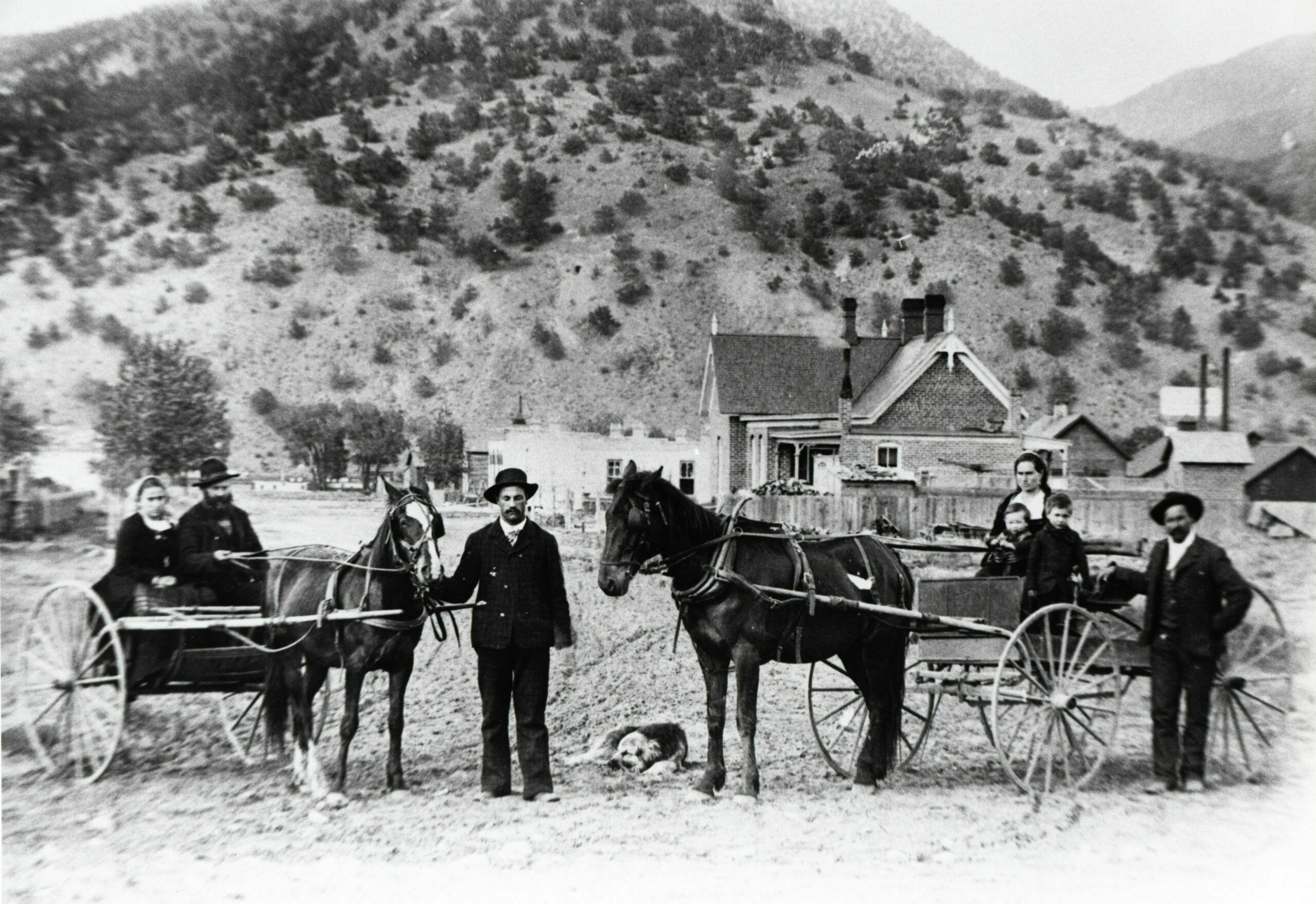 An unknown group. Tenderfoot Mountain is in the background, and 331 W. 2nd Street is the house on the right. It was built by William Van Every.
