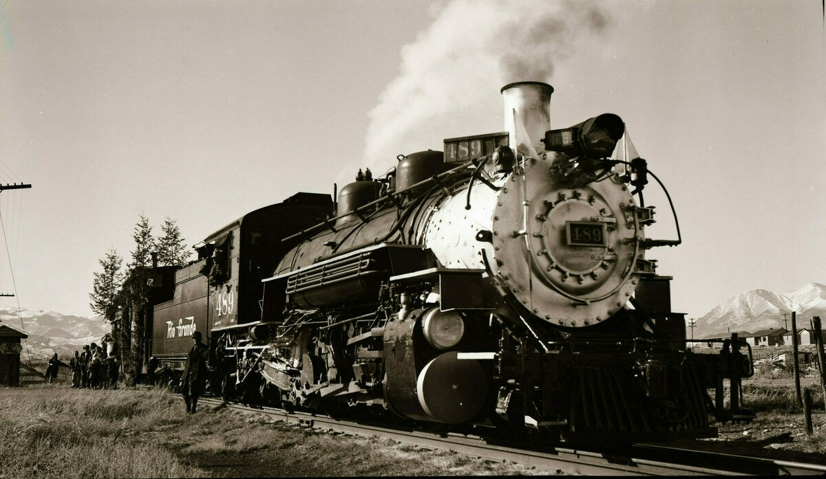 From the former museum director, Charles Albi, at the Railroad Museum:  "That's good old D&RGW 268 still painted in the yellow color of its Chicago Railroad Fair, 1948-49 role disguised as the Montezuma, the first Denver & Rio Grande locomotive. The Cripple Creek and Tin Cup came out of some publicist's fertile imagination of the Old West. Historic preservation was in its infancy in those days! The caboose is 0578, now here at the museum. The occasion is one of the Santa Claus trains put on by the railroad employees in Salida. It would go about a mile out of town, then come whistling in with the jolly old gent on the back platform tossing candy to all the little kids."